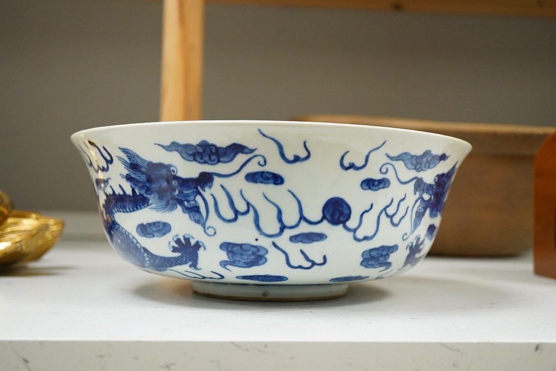 A Chinese blue and white dragon bowl, Kangxi mark but later, 26cm diameter